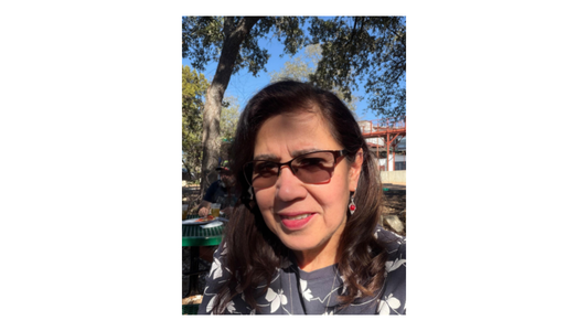 Mariel wearing red earrings and glasses