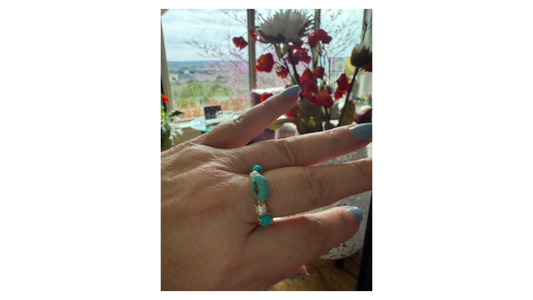 Ring in Mariel's hand made with turquoises