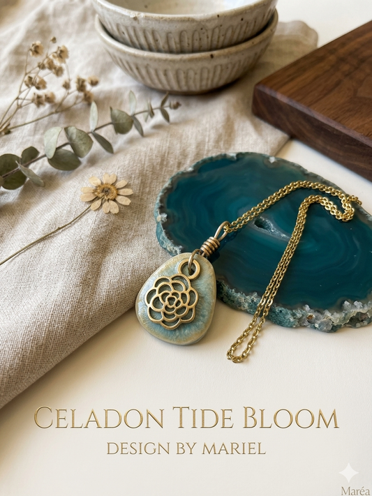 Necklace with a pendant on a blue stone, surrounded by dried flowers and ceramic bowls.
