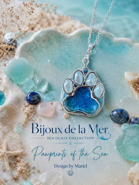 Blue paw-shaped pendant necklace on a textured surface with 'Bijoux de la Mer' branding.