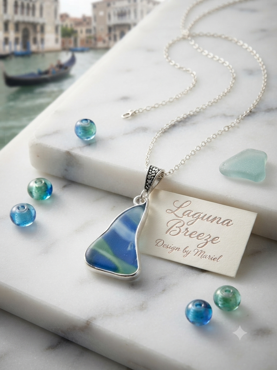 A silver necklace with a triangular blue and green marbled pendant, displayed on a white marble slab with decorative glass beads and a branded tag reading 'Laguna Breeze Design by Marisol'.